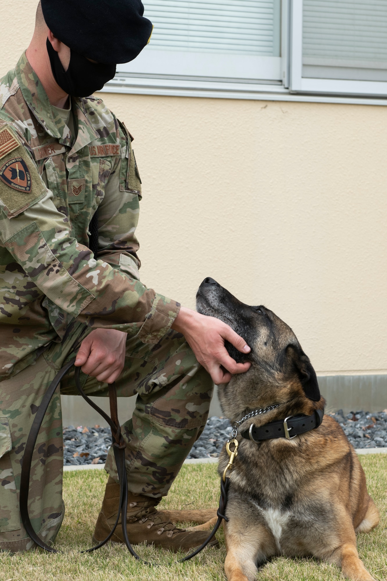 Staff Sgt. Colin Schweir, 374th Security Forces Squadron military working dog handler, pets MWD Edy at the “Day in the Life” event during National Police Week at Yokota Air Base, Japan, May 11, 2021.  Security forces brought out two MWDs to provide the base insight on what the SFS does and how they train. (U.S. Air Force photo by Staff Sgt. Joshua Edwards)