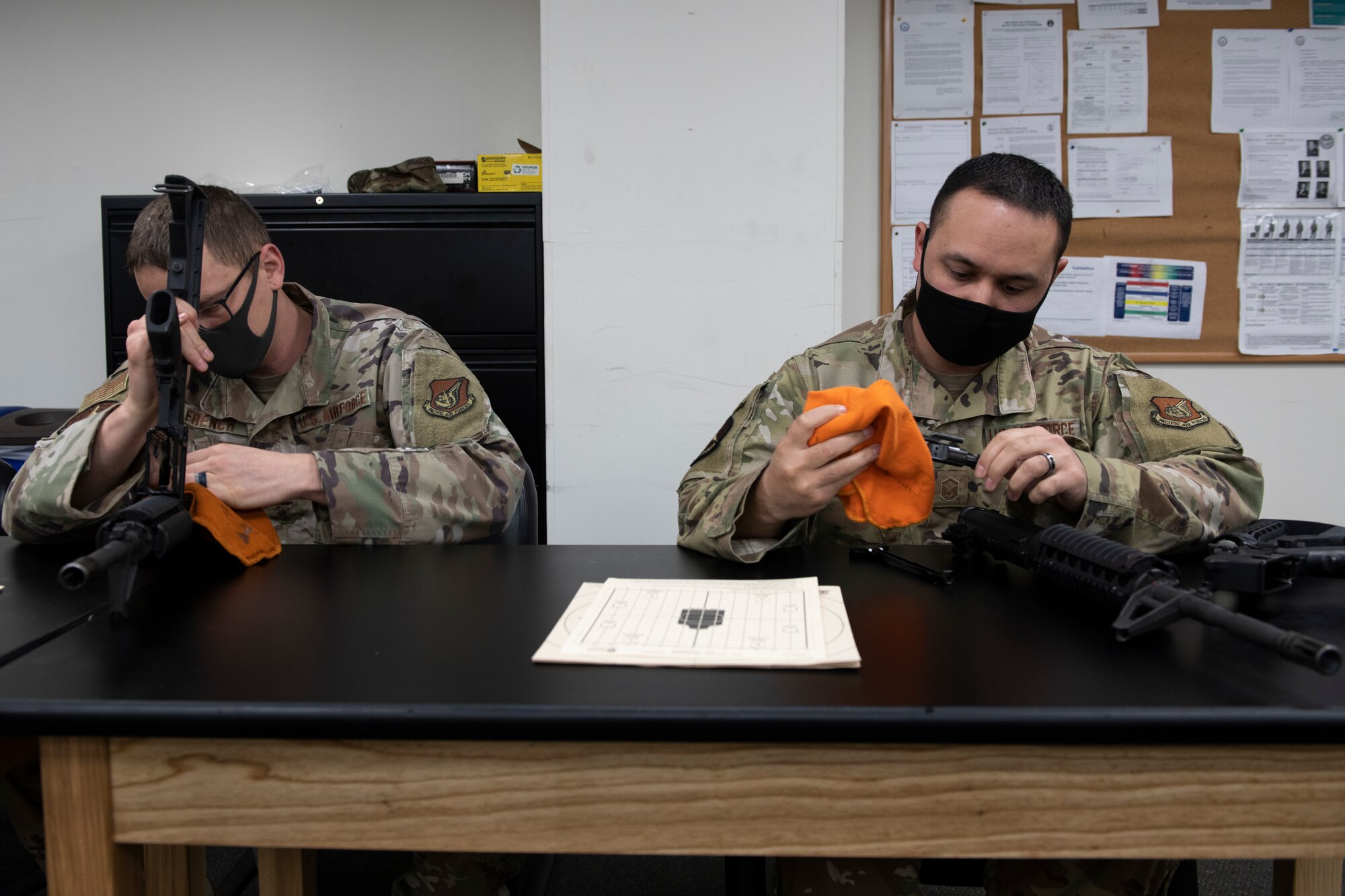 Master Sgts. Daniel French, left, and Derek Spencer, 374th Maintenance Squadron aircraft structural maintainers, inspect their M4 carbines before a shooting competition during National Police Week at Yokota Air Base, Japan, May 12, 2021. Each competitor was given a chance to inspect their weapon before the event and clean it, if needed. (U.S. Air Force photo by Staff Sgt. Joshua Edwards)