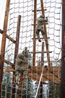 Alaska Army National Guardsmen descend on the obstacle course that is a part of the Alaska Army National Guard Best Warrior Competition May 15, 2021, at Joint Base Elmendorf-Richardson. The Best Warrior Competition recognizes Soldiers who demonstrate commitment to the Army values and embody the warrior ethos. (U.S. Army National Guard photo by Spc. Marc Marmeto).