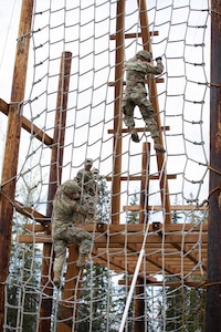 Alaska Army National Guardsmen descend on the obstacle course that is a part of the Alaska Army National Guard Best Warrior Competition May 15, 2021, at Joint Base Elmendorf-Richardson. The Best Warrior Competition recognizes Soldiers who demonstrate commitment to the Army values and embody the warrior ethos. (U.S. Army National Guard photo by Spc. Marc Marmeto).