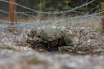 Alaska Army National Guardsman Spc. Jysamon Sanouvong, a military police officer assigned to the 49th Military Police Ground Based Interceptor Security Company, goes through the obstacle course portion of the Alaska Army National Guard Best Warrior Competition May, 15, 2021 at Joint Base Elmendorf-Richardson. The Best Warrior Competition recognizes Soldiers who demonstrate commitment to the Army values and embody the warrior ethos. (U.S. Army National Guard photo by Spc. Marc Marmeto).