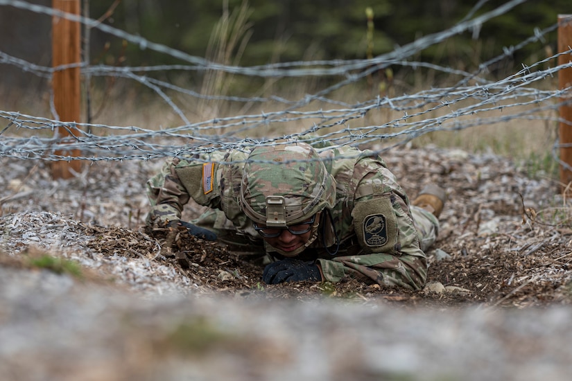 Alaska Army National Guardsman Spc. Jysamon Sanouvong, a military police officer assigned to the 49th Military Police Ground Based Interceptor Security Company, goes through the obstacle course portion of the Alaska Army National Guard Best Warrior Competition May, 15, 2021 at Joint Base Elmendorf-Richardson. The Best Warrior Competition recognizes Soldiers who demonstrate commitment to the Army values and embody the warrior ethos. (U.S. Army National Guard photo by Spc. Marc Marmeto).