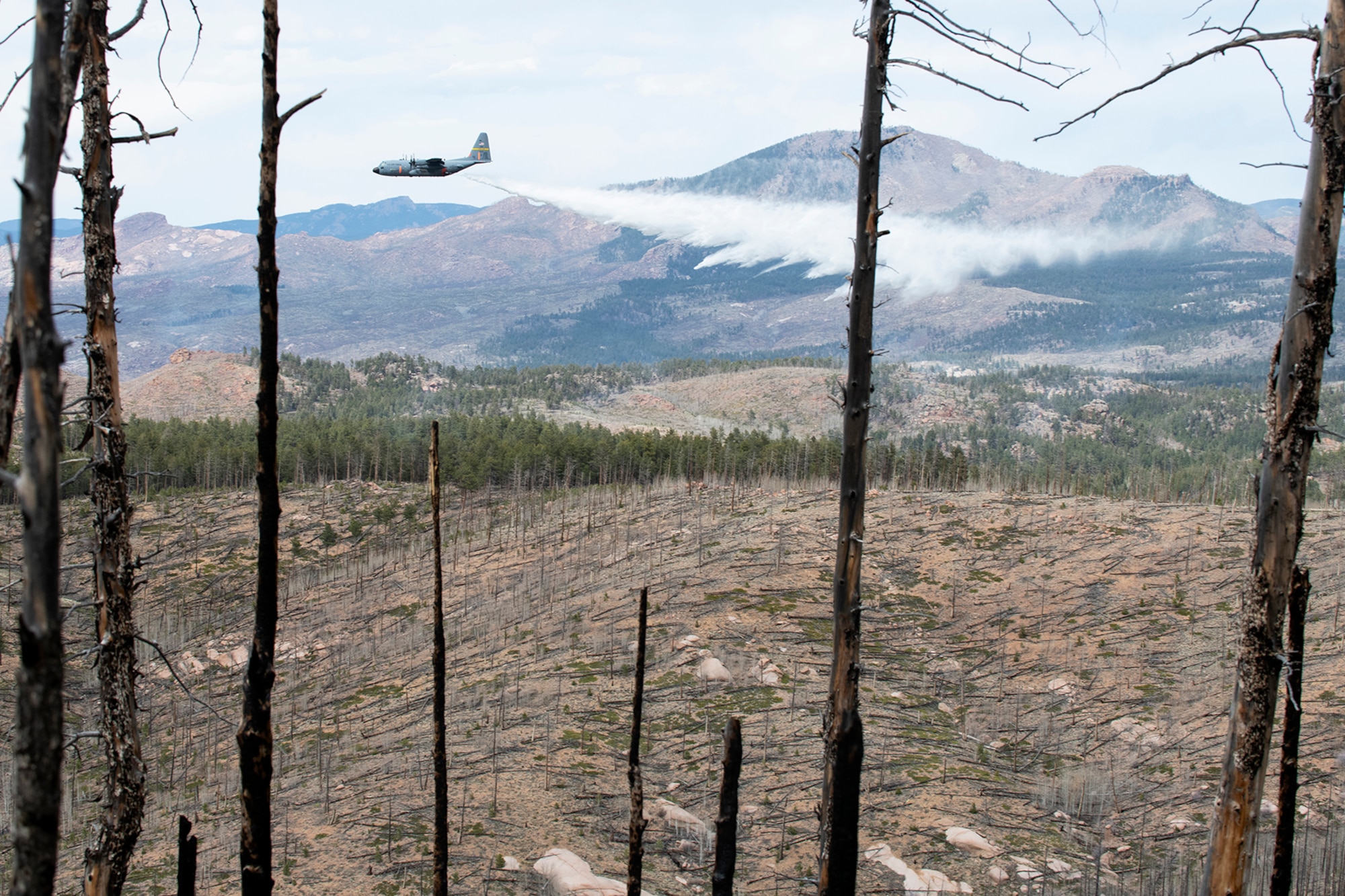 C-130 dropping potable water on mountain ridge