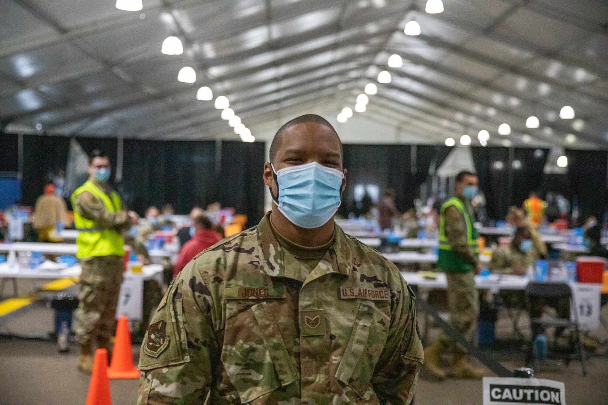 U.S. Air Force Staff Sgt. Deshaun Jones, an Airman assigned to the 6th Force Support Squadron based in Tampa, Florida, poses for a photo at the Community Vaccination Center (CVC) at the Minnesota State Fairgrounds in St. Paul, Minnesota, April 26, 2021. The CVC is completely operational and is welcoming the St. Paul community to receive free COVID-19 vaccines. U.S. Northern Command, through U.S. Army North, remains committed to providing continued, flexible Department of Defense support to the Federal Emergency Management Agency as part of the whole-of-government response to COVID-19. (U.S. Army photo by Spc. Hunter Garcia)