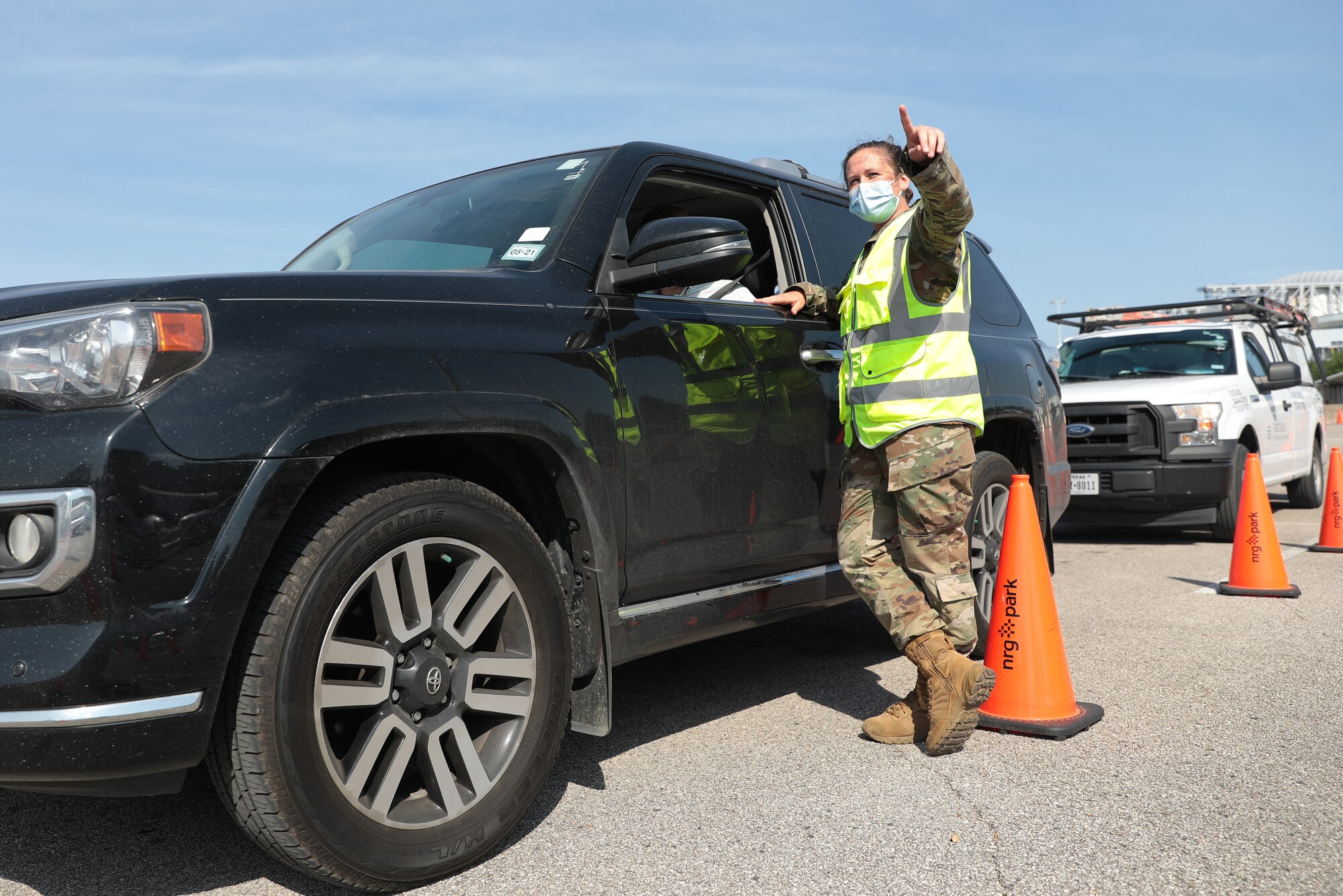 U.S. Air Force 1st Lt. Marissa Sunnekalb, a clinical nurse with the 64th Expeditionary Medical Operations Squadron, checks in on a Houston resident after receiving the COVID-19 vaccine at the Community Vaccination Center at the NRG in Houston, Texas, April 26, 2021. Sunnekalb, a Mohrsville, Pennsylvania native, is stationed at Offutt Air Force Base and serves on the post-vaccine observation team as an alternate team leader at the NRG Stadium CVC. U.S. Northern Command, through U.S. Army North, remains committed to providing continued, flexible Department of Defense support to the whole-of-government COVID-19 response. (U.S. Army photo by Spc. Joseph E. D. Knoch/5th Mobile Public Affairs Detachment)