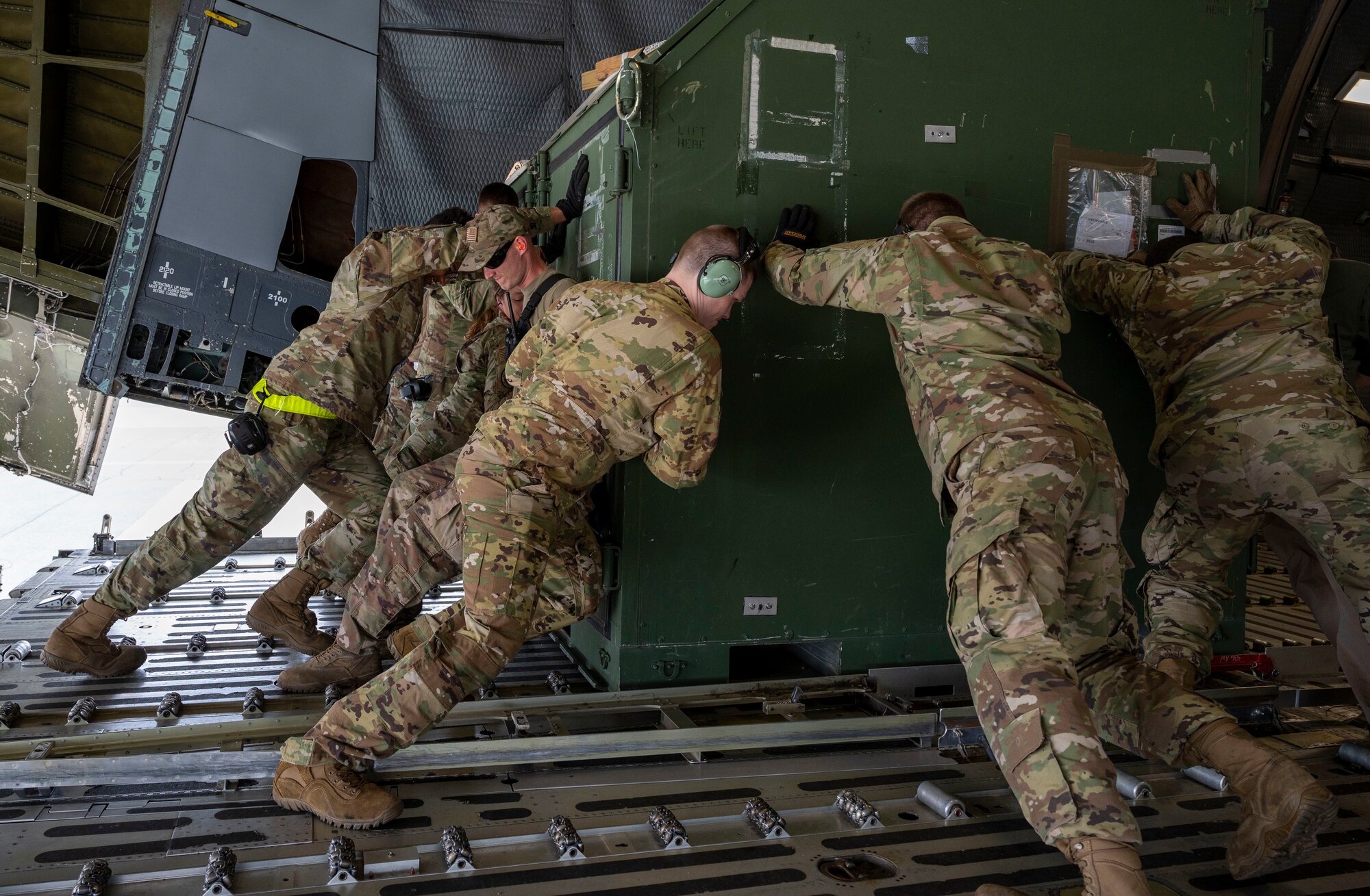 Team Dover Airmen load cargo into a C-5M Super Galaxy at Dover Air Force Base, Delaware, prior to departure for Exercise Mobility Guardian 2021, May 16, 2021. Exercise Mobility Guardian is Air Mobility Command’s largest and longest training event. Airmen are tested through a challenging, realistic and detailed scenario based on real-world challenges. More than 80 Team Dover Airmen departed in support of the exercise. (U.S. Air Force photo by Airman 1st Class Cydney Lee)