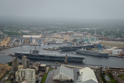 The aircraft carrier USS Harry S. Truman (CVN 75), front, passes the aircraft carrier USS George H. W. Bush (CVN 77).