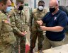 Russ Kropp, a U.S. Army Tank-automotive and Armaments Command employs Logistics Assistance Representative assigned to the 405th Army Field Support Brigade’s Army Field Support Battalion-Germany, shows a group of Soldiers from the 92nd Military Police Company how to check a Humvee brake-torque converter cutout switch.