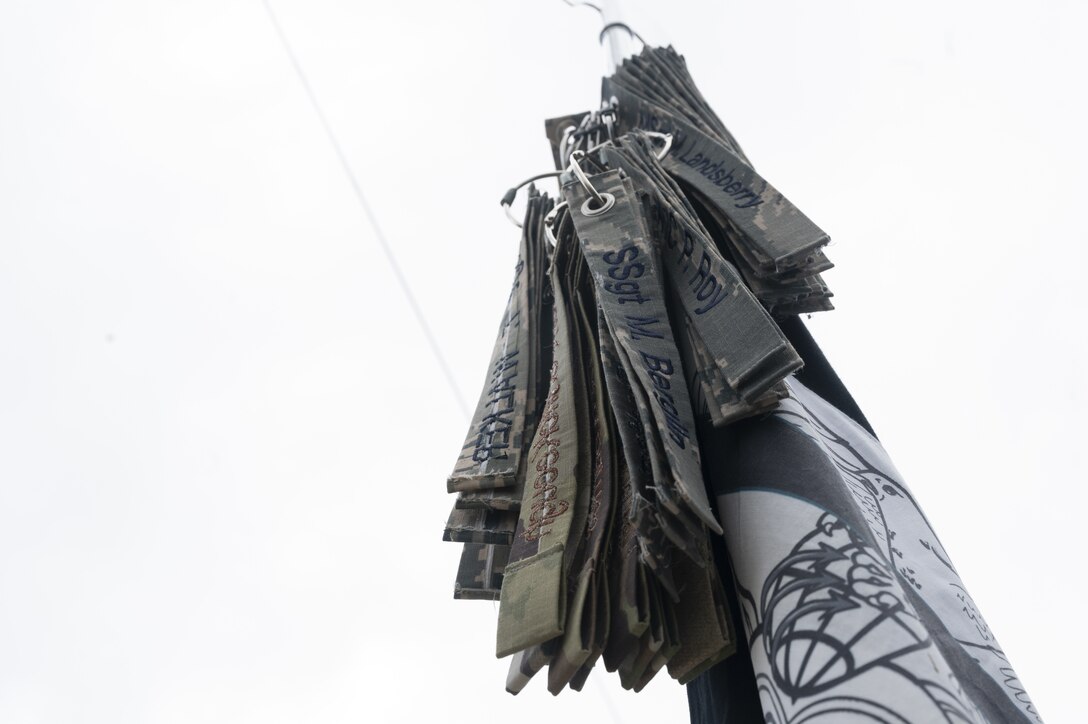 Nametapes of fallen members rest on a guide-on.