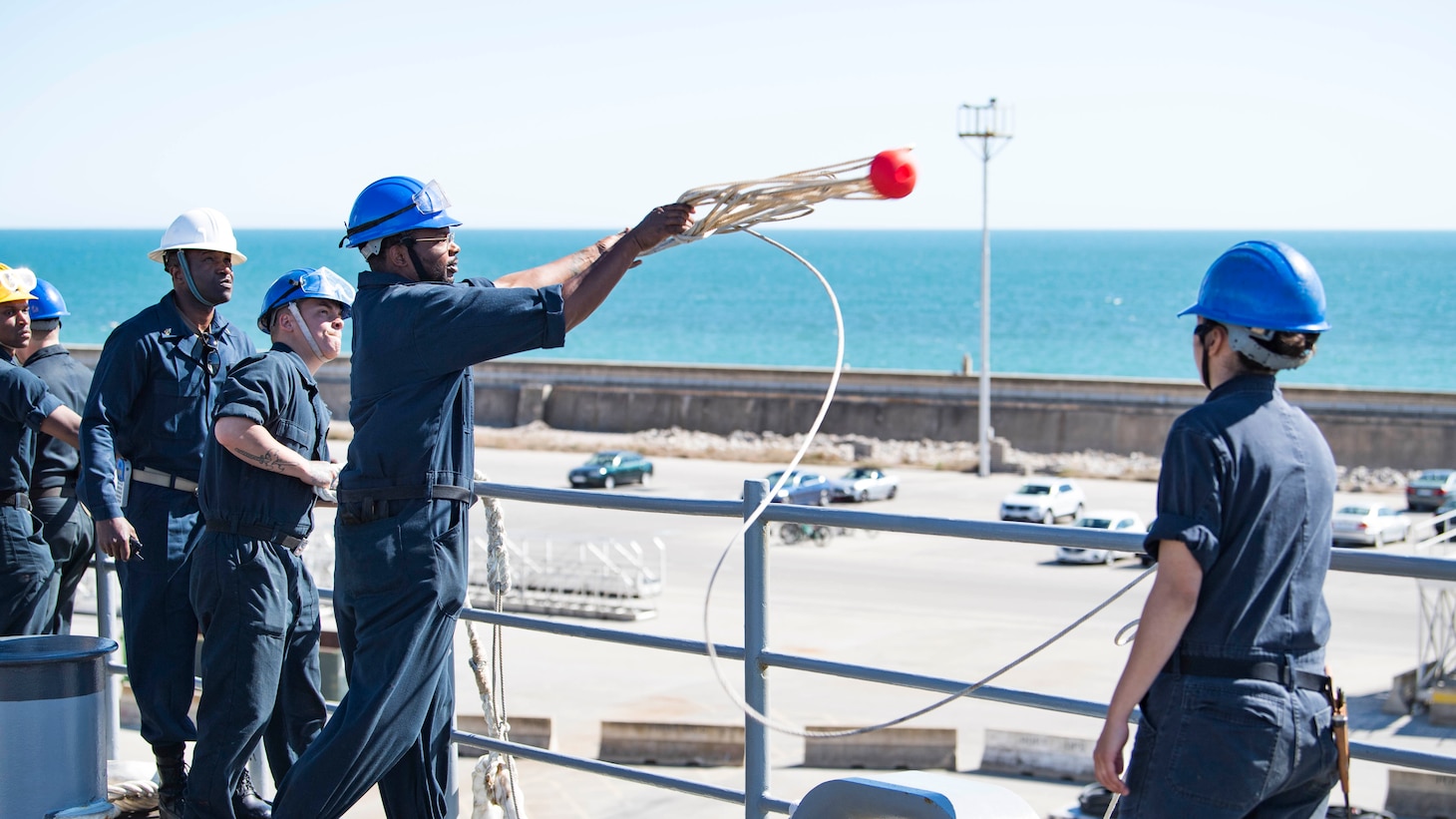 Boatswain's Mate Seaman Bobby Mosley, assigned to the Harpers Ferry-class dock landing ship USS Carter Hall (LSD 50), heaves line during a sea and anchor evolution, May 17, 2021. Carter Hall is operating in the Atlantic Ocean with Amphibious Squadron 4 and the 24th Marine Expeditionary Unit (MEU) as part of the Iwo Jima Amphibious Ready Group.