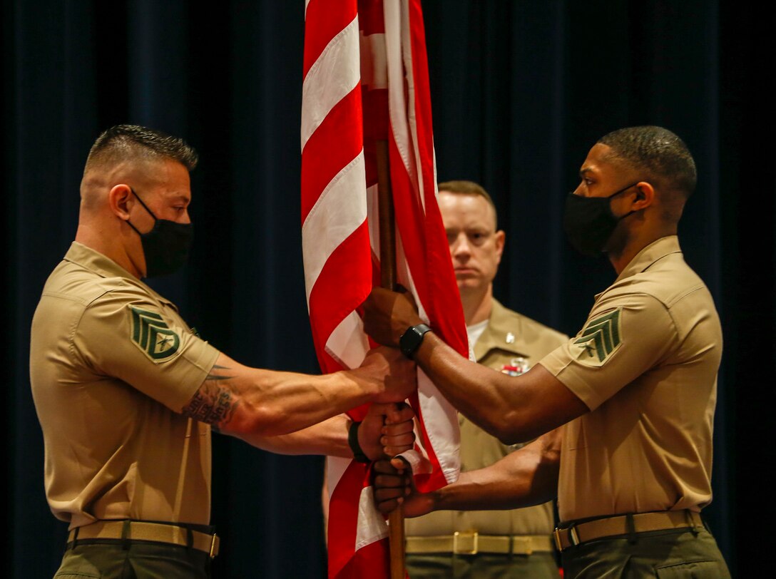 Staff Sgt. Franklin D. Taft, 39th Color Sergeant of the Marine Corps, passes the National Ensign to Sgt. Cameron Williams, during a relief and appointment ceremony at Marine Barracks Washington, D.C., May 17, 2021. The Color Sergeant of the Marine Corps serves as the senior sergeant of the Corps, entrusted with carrying the National Ensign in ceremonies throughout the National Capital Region and across the nation. The Color Sergeant leads the official Color Guard Platoon at MBW at is responsible for training and preparing the Marines for future service in the operating forces. (U.S. Marine Corps photo by Lance Cpl. Allen Sanders)