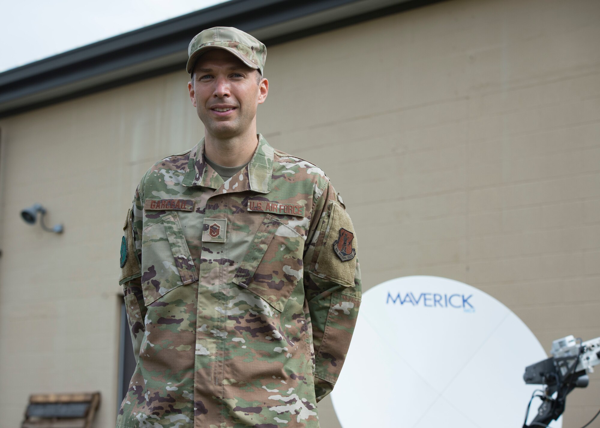 Air Force Master Sgt. Seth Garceau, a member of the 103rd Communications Squadron, stands in front of a satellite dish that he set up, Sept. 30, 2020 at Bradley Air National Guard Base, Conn. The set up was part of an expansive communications project. (U.S. Air National Guard photo by Tech. Sgt. Tamara R. Dabney)
