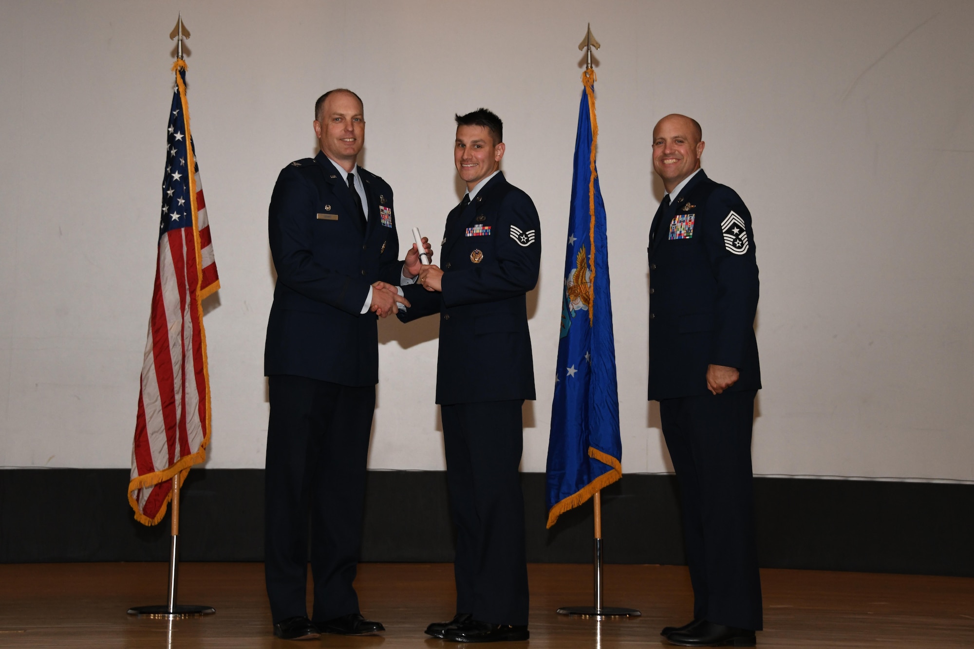 Three men accept certificate.