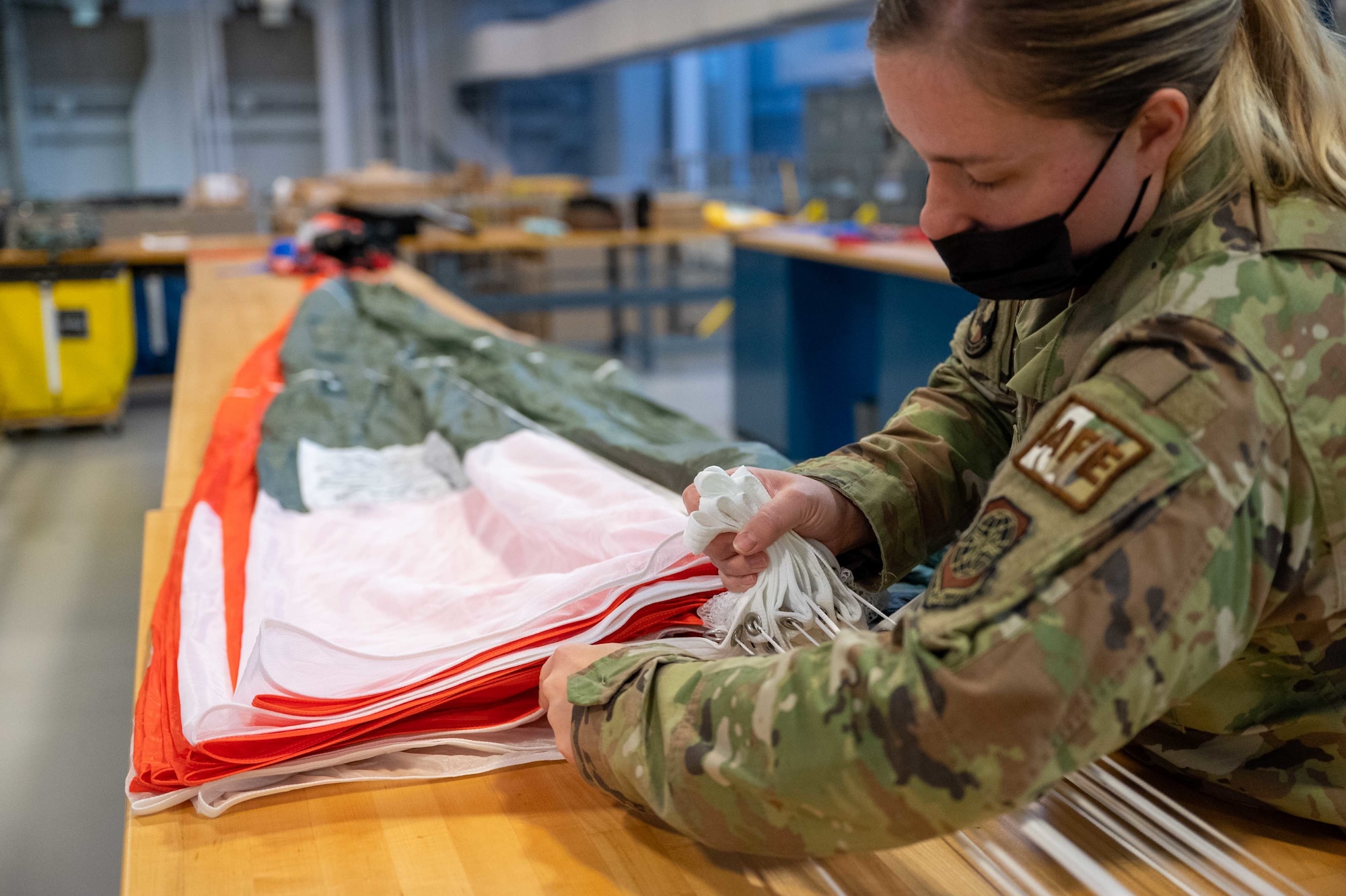 Staff Sgt. Nicole Harper, 436th Operations Support Squadron aircrew flight equipment supervisor, prepares a new BA-30 parachute for packing at Dover Air Force Base, Delaware, May 6, 2021. AFE members ensure all flight and safety equipment on board all Dover AFB aircraft is in working order. (U.S. Air Force photo by Airman 1st Class Faith Schaefer)
