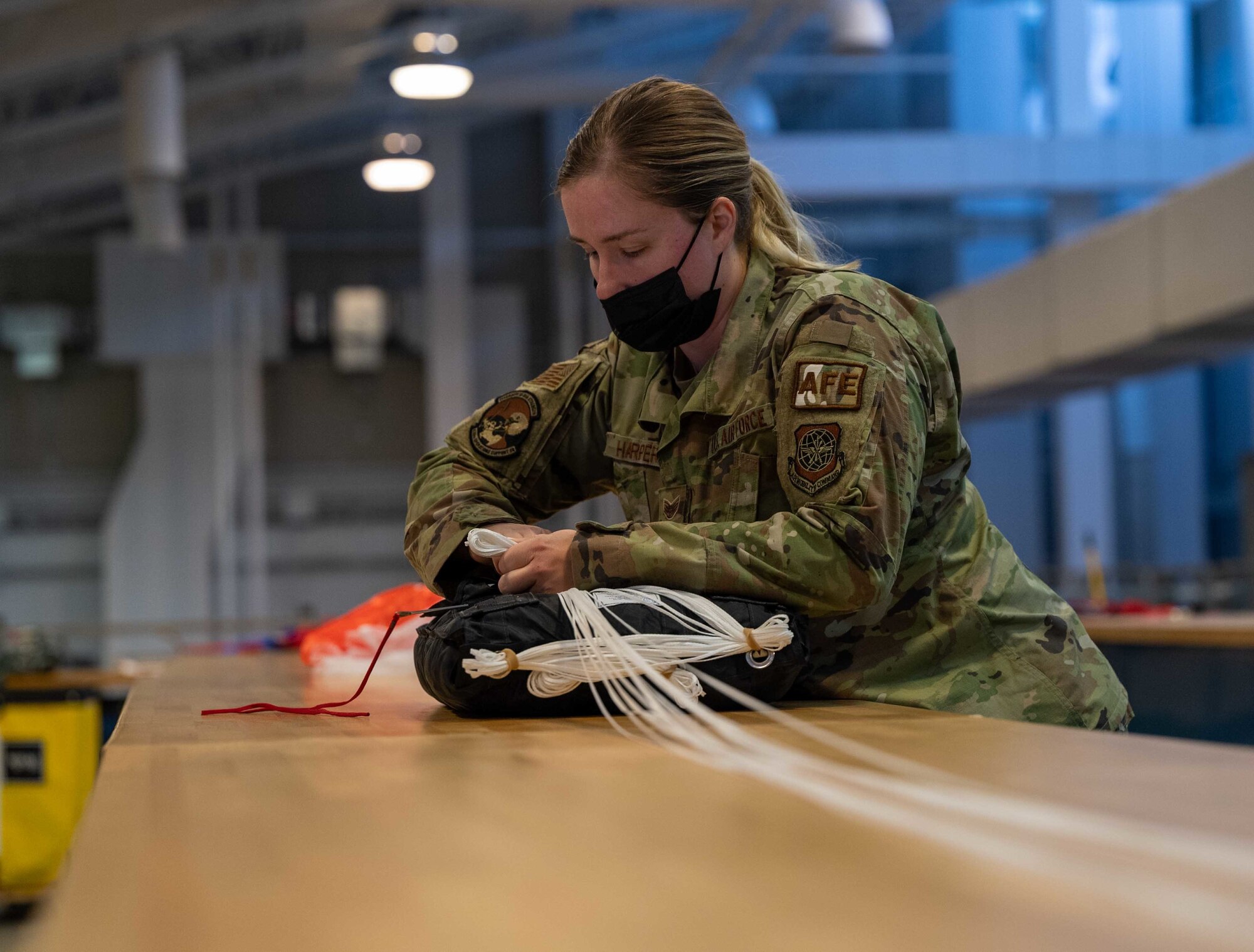 Staff Sgt. Nicole Harper, 436th Operations Support Squadron aircrew flight equipment supervisor, prepares a new BA-30 parachute to be packed at Dover Air Force Base, Delaware, May 6, 2021. AFE members are responsible for ensuring all flight and safety equipment is in working order on Dover aircraft. (U.S. Air Force photo by Airman 1st Class Faith Schaefer)