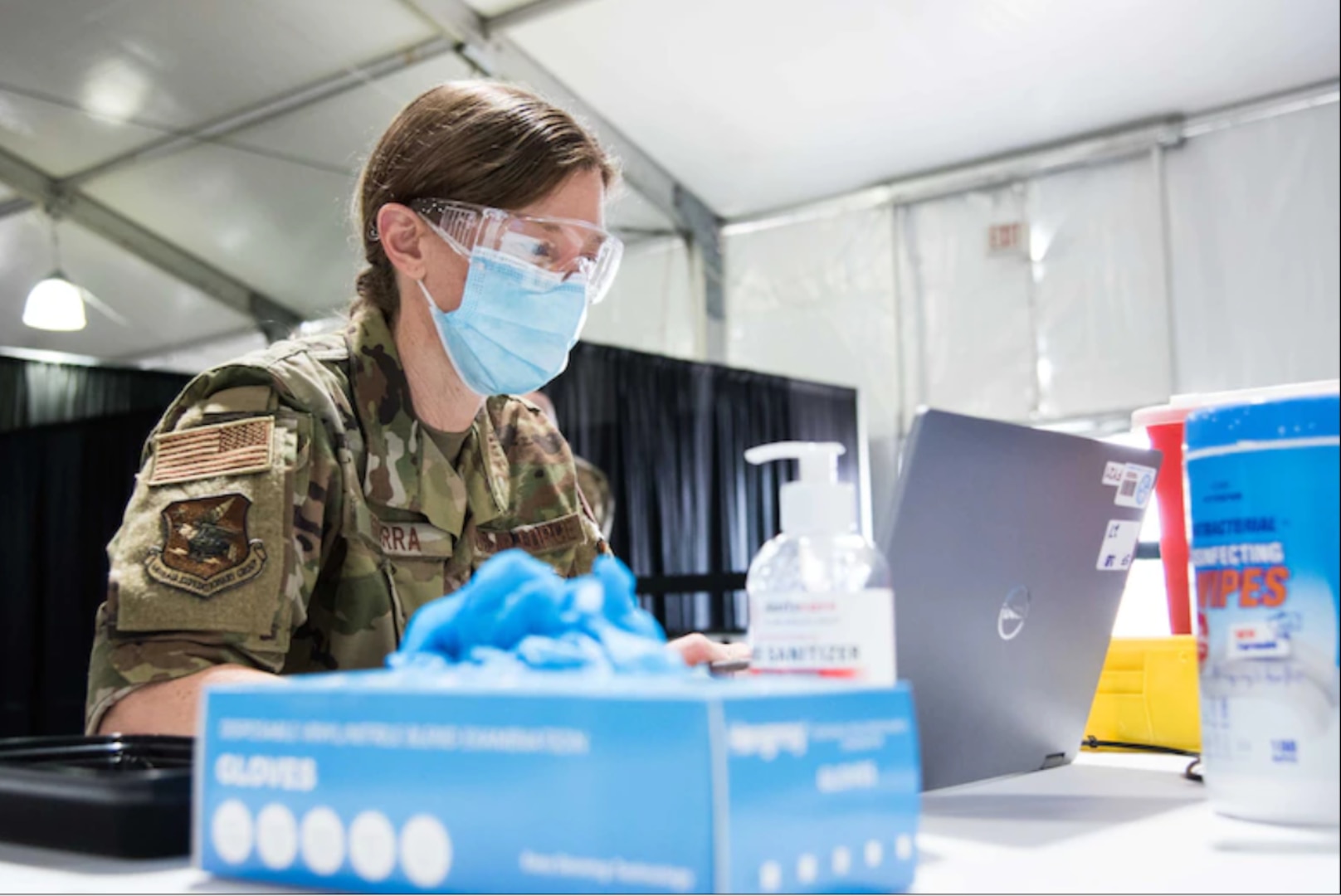 U.S. Air Force Maj. Helena Guerra, 22nd Medical Group bravo flight commander, prepares her station for her next COVID-19 vaccine patient April 28, 2021, at the Community Vaccination Center (CVC) in St. Paul, Minnesota. The total-force team consists of approximately 140 Airmen from 24 installations across the country. (U.S. Air Force photo by Senior Airman Alexi Bosarge)