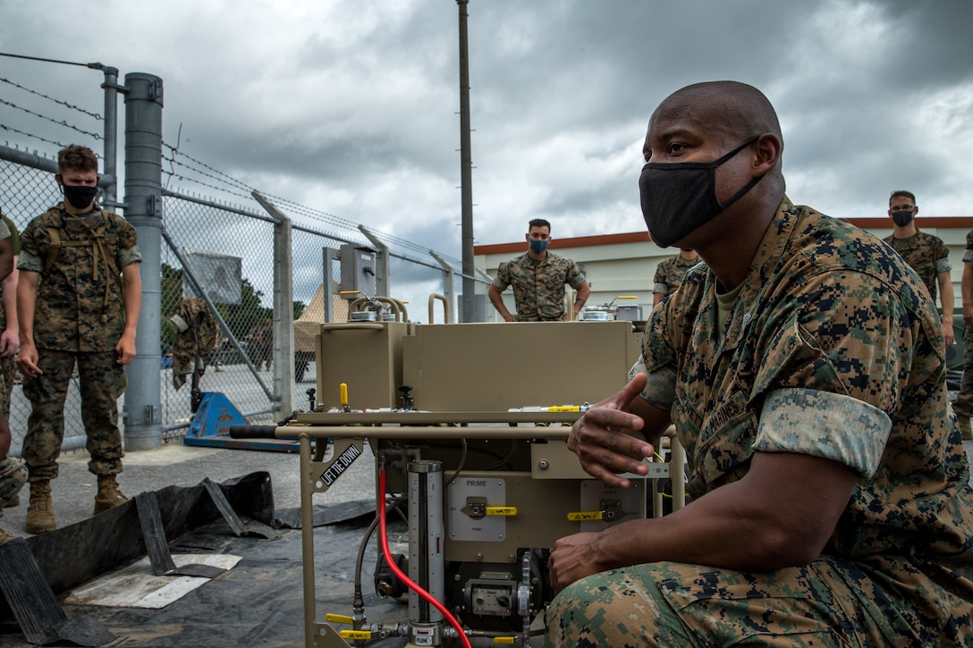 U.S. Marine Corps Sgt. Calvin Gravette III, a bulk fuel specialist with Bulk Fuel Company, 9th Engineer Support Battalion, 3rd Marine Logistics Group, instructs Marines on the Expeditionary Mobile Fuel Additization on Camp Hansen, Okinawa, Japan, May 12, 2021. Gravette is a graduate from the EMFAC New Equipment Training, and is the lead EMFAC training instructor for III Marine Expeditionary Force. 3rd MLG, based out of Okinawa, Japan, is a forward deployed combat unit that serves as III MEF’s comprehensive logistics and combat service support backbone for operations throughout the Indo-Pacific area of responsibility.