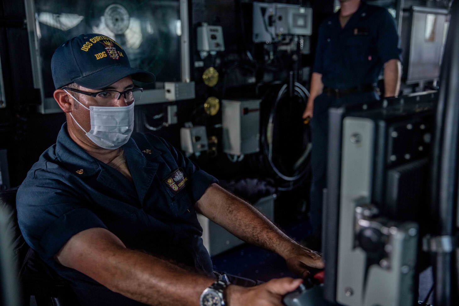 TAIWAN STRAIT (May 18, 2021) – Senior Chief Sonar Technician (Surface) Kenneth Dunne, from Fort Lauderdale, Fla., stands watch on the bridge of the Arleigh Burke-class guided-missile destroyer USS Curtis Wilbur (DDG 54) as the ship conducts routine operations. Curtis Wilbur is assigned to Commander, Task Force 71/Destroyer Squadron (DESRON) 15, the Navy’s largest forward DESRON and the U.S. 7th Fleet’s principal surface force. (U.S. Navy photo by Mass Communication Specialist 3rd Class Zenaida Roth)
