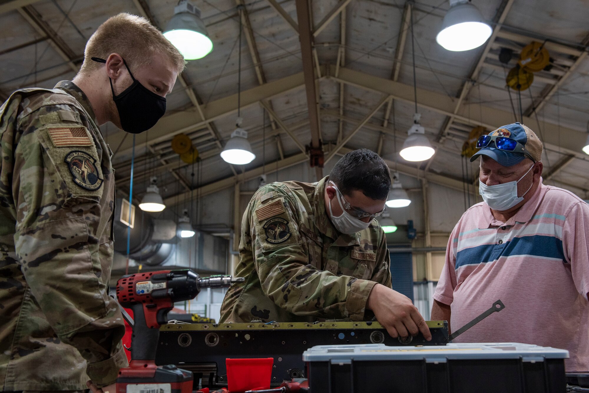 Sam Mckinnon, right, Air Force Engineering and Technical Services weapons specialist, trains armament maintenance specialists at Seymour Johnson Air Force Base, North Carolina, May 6, 2021.