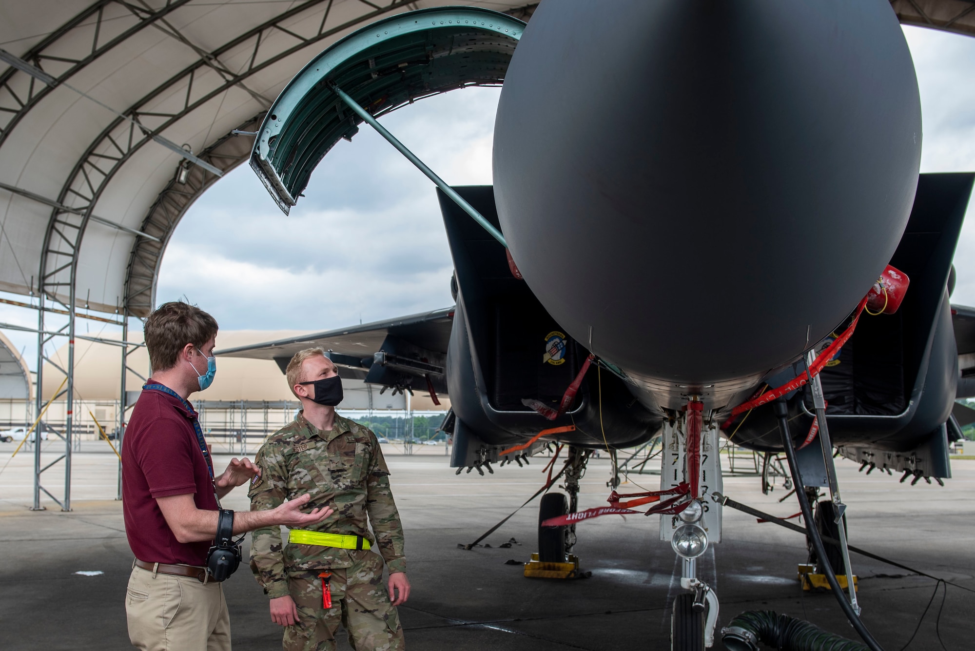 Josh Winowiecki, left, Air Force Engineering and Technical Services lead and avionics specialist, teaches Airman 1st Class Nathan Jester, 336th Fighter Squadron avionics technician, about a new avionics’ modification on the F-15E Strike Eagle at Seymour Johnson Air Force Base, North Carolina, May 6, 2021.