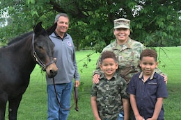 soldier with family and unit mascot blackjack the mule