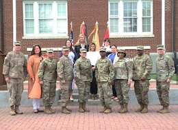 volunteers stand with commanding general after receiving awards