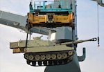 A M109A6 Paladin howitzer assigned to Bravo Battery, 1st Battalion, 214th Field Artillery Regiment, 648th Maneuver Enhancement Brigade, Georgia Army National Guard, is lifted onto a cargo ship May 10, 2021, in Jacksonville, Florida. The Georgia Army National Guard’s participation in exercise African Lion 21 allowed the organization to train on railhead and port operations.