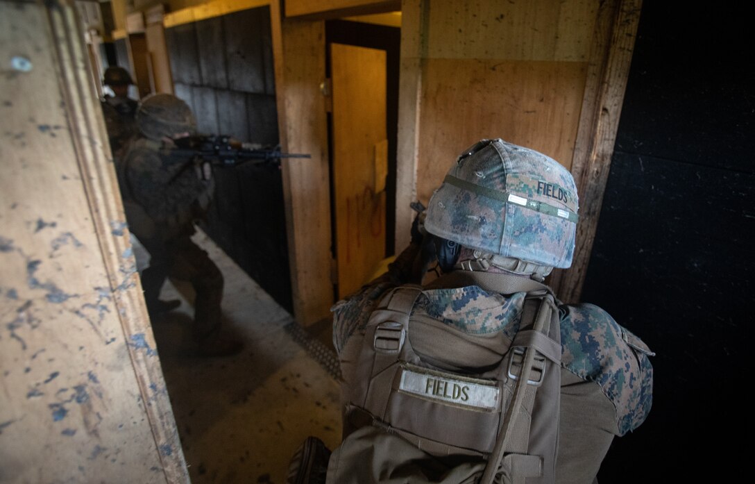 U.S. Marine Corps Cpl. Jake Fields, a basic security guard with Fleet Anti-Terrorism Security Team-Pacific (FASTPAC)  Company, Marine Security Force Regiment, begins to enter a room during interior tactics training at Camp Hansen, Okinawa, Japan, Dec. 10, 2020. Marines with FASTPAC Company utilized Camp Hansen’s indoor range to practice interior tactics and improve close quarter combat proficiency. (U.S. Marine Corps photo by Sgt. Micha Pierce)