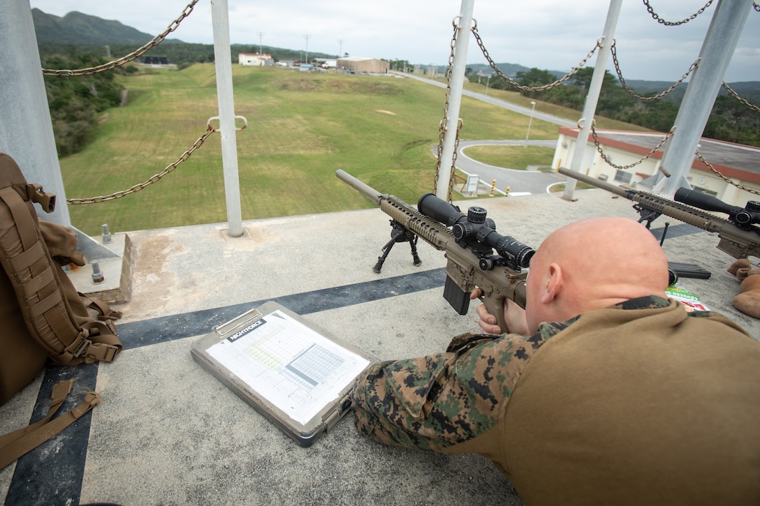 Cpl Miller sights in from the top of the Sniper Tower