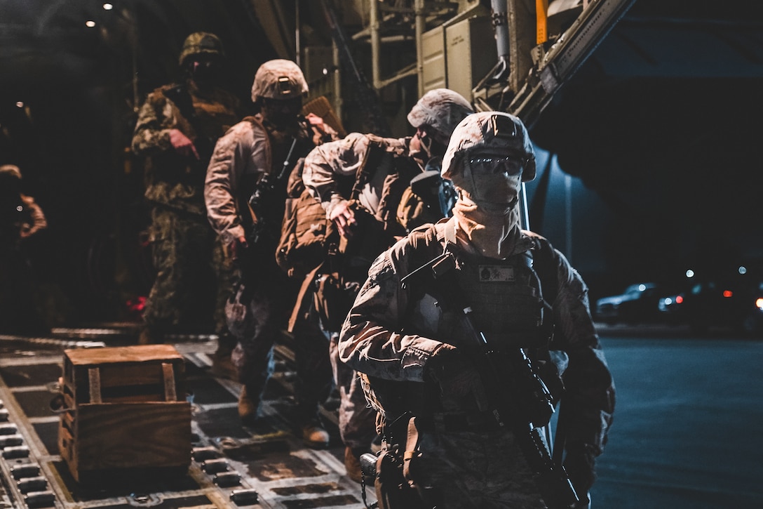 U.S. Marines with Fleet Anti-terrorism Security Company, Europe (FASTEUR), U.S. Navy Sailors with Explosive Ordnance Disposal Mobile Unit 8 (EODMU 8), and Naval Construction Forces, the “Seabees”, Commander, Task Force - 68 (CTF-68) personnel disembark a U.S. Air Force C-130 in Niamey, Niger, April 15, 2021 for a joint forces readiness exercise in Mali, Africa. U.S. forces routinely conduct operational and logistics assessment exercises across regions to prepare for contingencies, exercise readiness, and identify areas of improvement. (U.S. Marine Corps photo by Sgt. William Chockey)