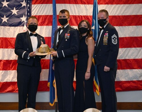 Lt. Gen. Jim Slife, Air Force Special Operations Command commander, and Chief Master Sgt. Cory Olson, AFSOC command chief, pose for a photo with Capt. Nate Peeler and his wife after presenting Peeler with AFSOC's Outstanding Airman of the Year Award for the Company Grade Officer category during a ceremony at Hurlburt Field, Florida May