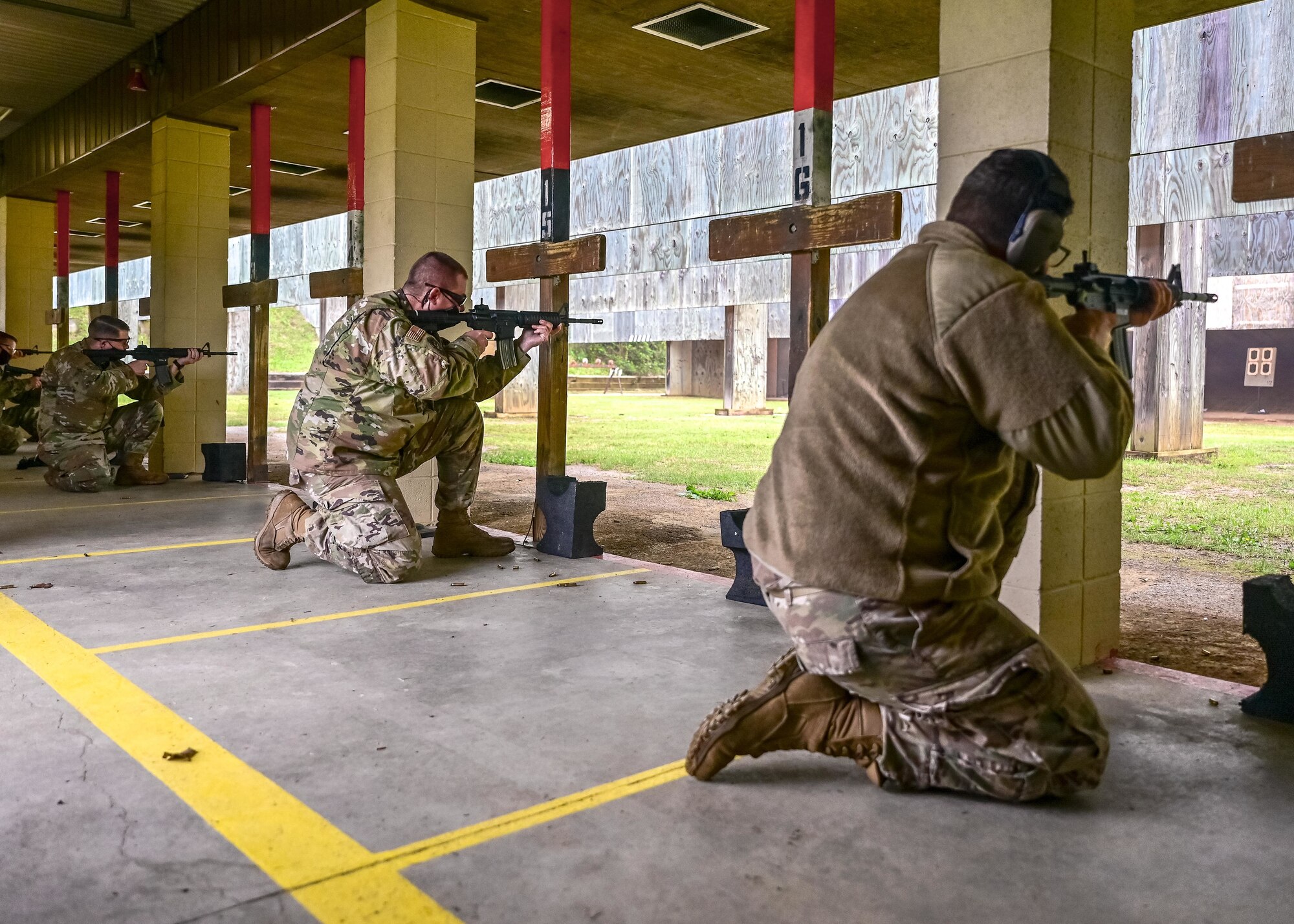 Airmen fire their M-4 rifle during a shooting competition