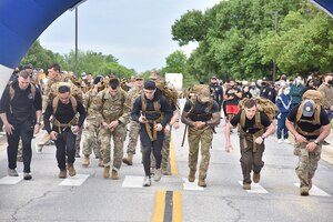 Airmen from the 316th Security Forces Group participate in a ruck march during National Police Week, May 11, 2021, at Joint Base Andrews, Md. National Police Week was established by Congress in 1962 to honor members of law enforcement who lost their lives in the line of duty. JBA celebrated National Police Week with a 5k run and ruck march, security forces demonstrations, bowling, a cornhole tournament, softball games and a barbecue. (U.S. Air Force photo by Senior Airman Daniel Brosam)