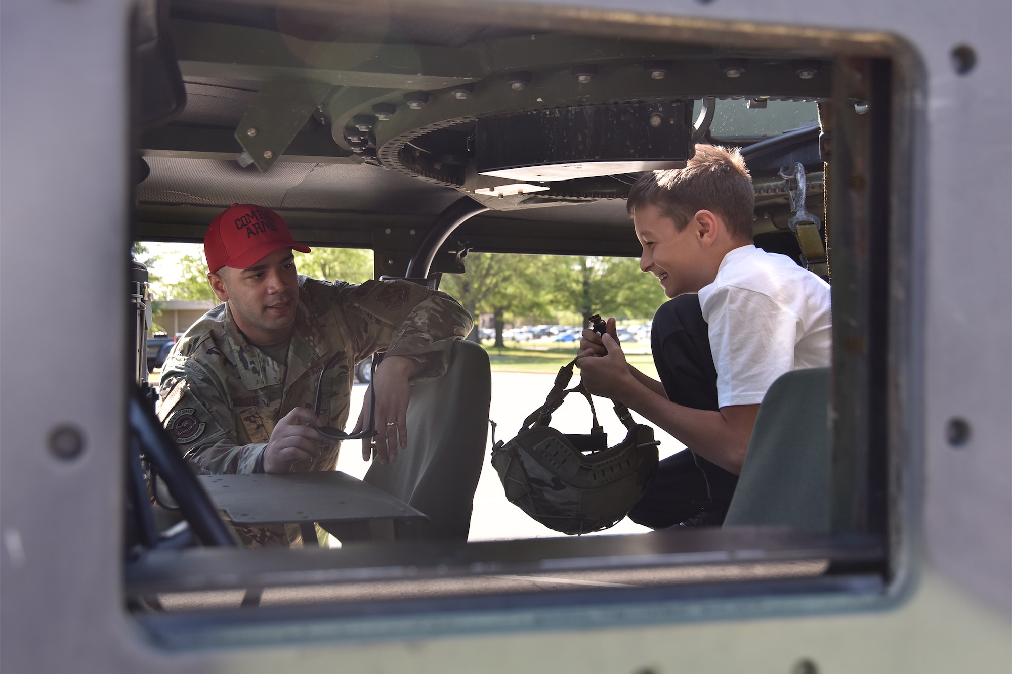 Staff Sgt. Victor Abreu, 316th Security Support Squadron combat arms instructor, speaks with Reagan Melvin, 9, during National Police Week security forces demonstrations, May 11, 2021, at Joint Base Andrews, Md. National Police Week was established by Congress in 1962 to honor members of law enforcement who lost their lives in the line of duty. JBA celebrated National Police Week with a 5k run and ruck march, security forces demonstrations, bowling, a cornhole tournament, softball games and a barbecue. (U.S. Air Force photo by Senior Airman Daniel Brosam)