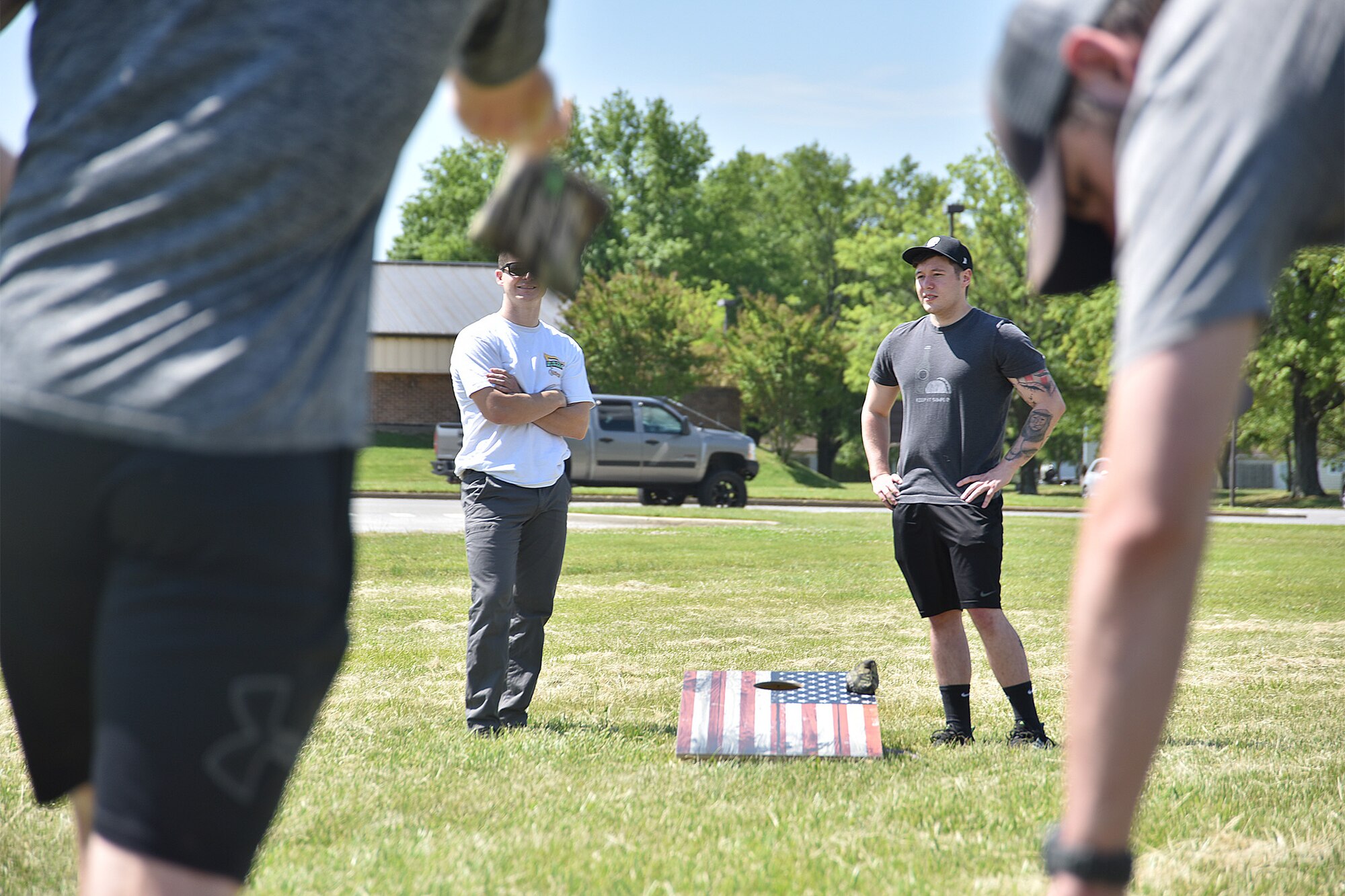 Airmen participate in a cornhole tournament during National Police Week, May 14, 2021, at Joint Base Andrews, Md. National Police Week was established by Congress in 1962 to honor members of law enforcement who lost their lives in the line of duty. JBA celebrated National Police Week with a 5k run and ruck march, security forces demonstrations, bowling, a cornhole tournament, softball games and a barbecue. (U.S. Air Force photo by Senior Airman Daniel Brosam)