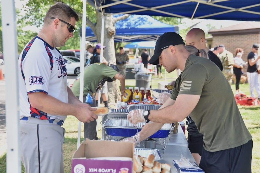 Airmen attend a barbecue during National Police Week, May 14, 2021, at Joint Base Andrews, Md. National Police Week was established by Congress in 1962 to honor members of law enforcement who lost their lives in the line of duty. JBA celebrated National Police Week with a 5k run and ruck march, security forces demonstrations, bowling, a cornhole tournament, softball games and a barbecue. (U.S. Air Force photo by Senior Airman Daniel Brosam)