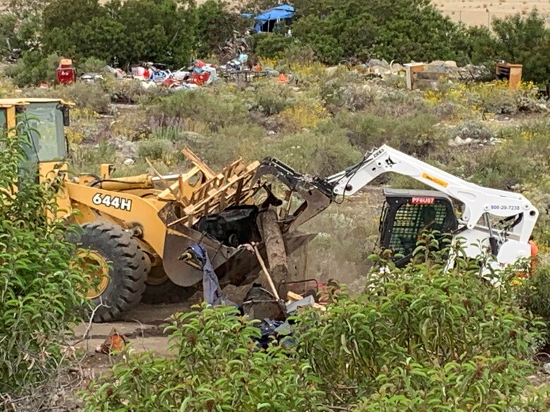 A small tracked skid steer pushes a load of debris to a loader, May 10, below the Santa Fe Dam in Irwindale, California. The cleanup by the U.S. Army Corps of Engineers Los Angeles District was done in five days.