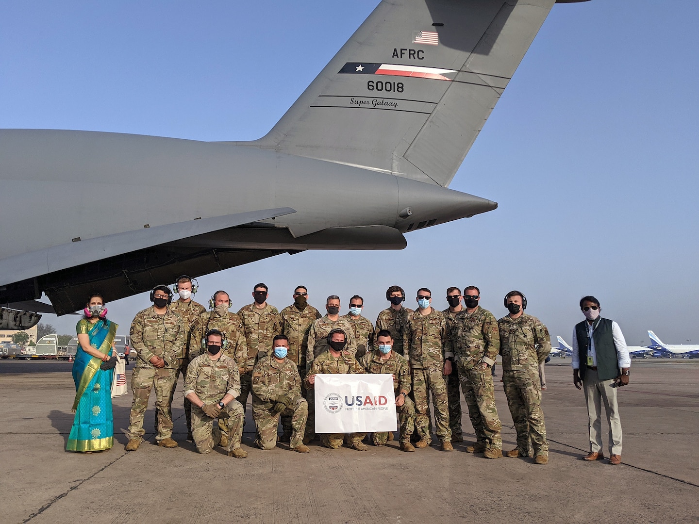 The crew of the 433rd Airlift Wing C-5M Super Galaxy "Reach 281" and others pose May 5 at the airport in New Delhi, India.