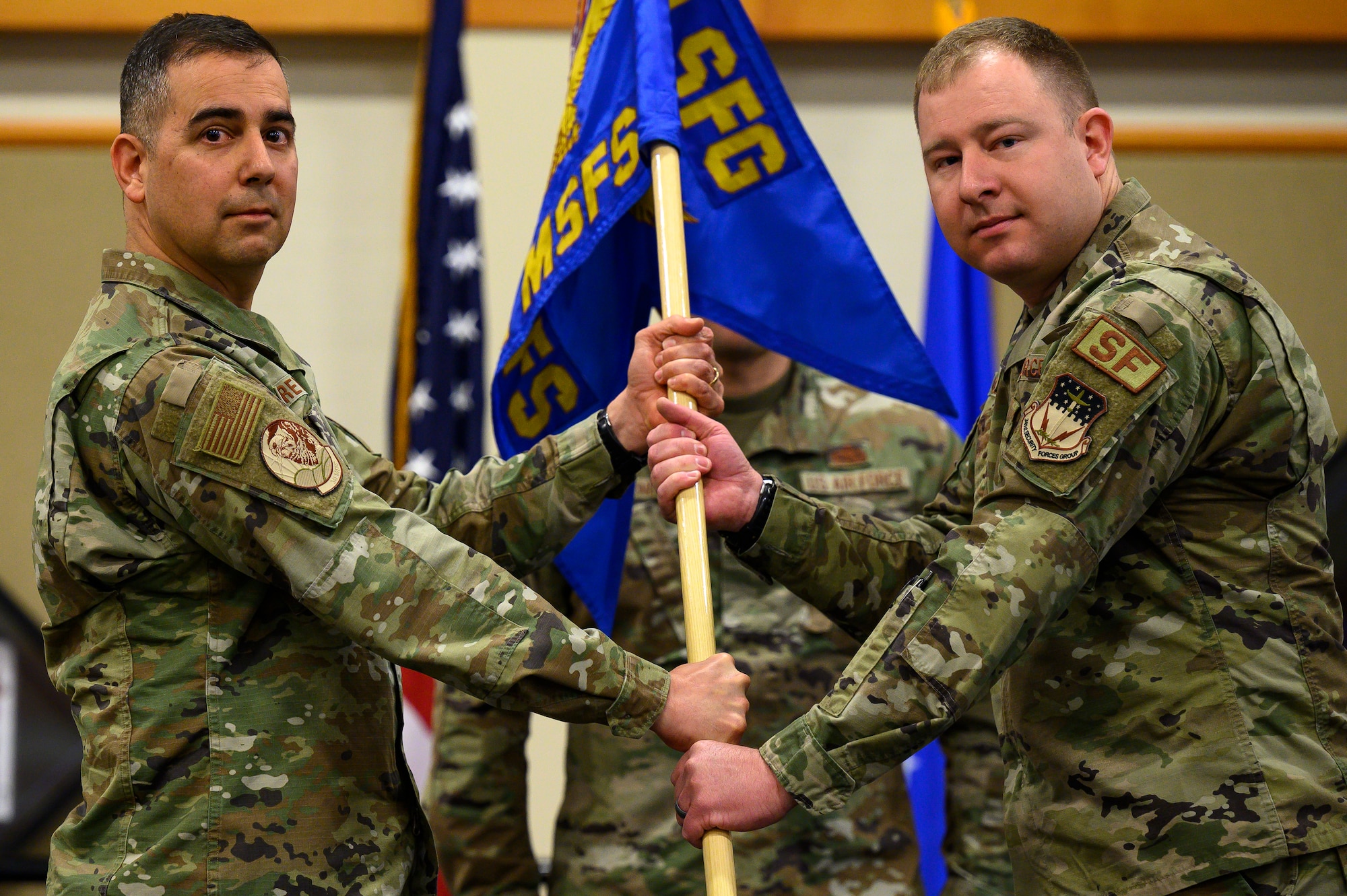 Maj. Richard Glover, right, accepts command of the 341st Missile Security Forces Squadron from Col. Frank Reyes, 341st Security Forces Group commander, during a change of command ceremony May 18, 2021, at Malmstrom Air Force Base, Mont.