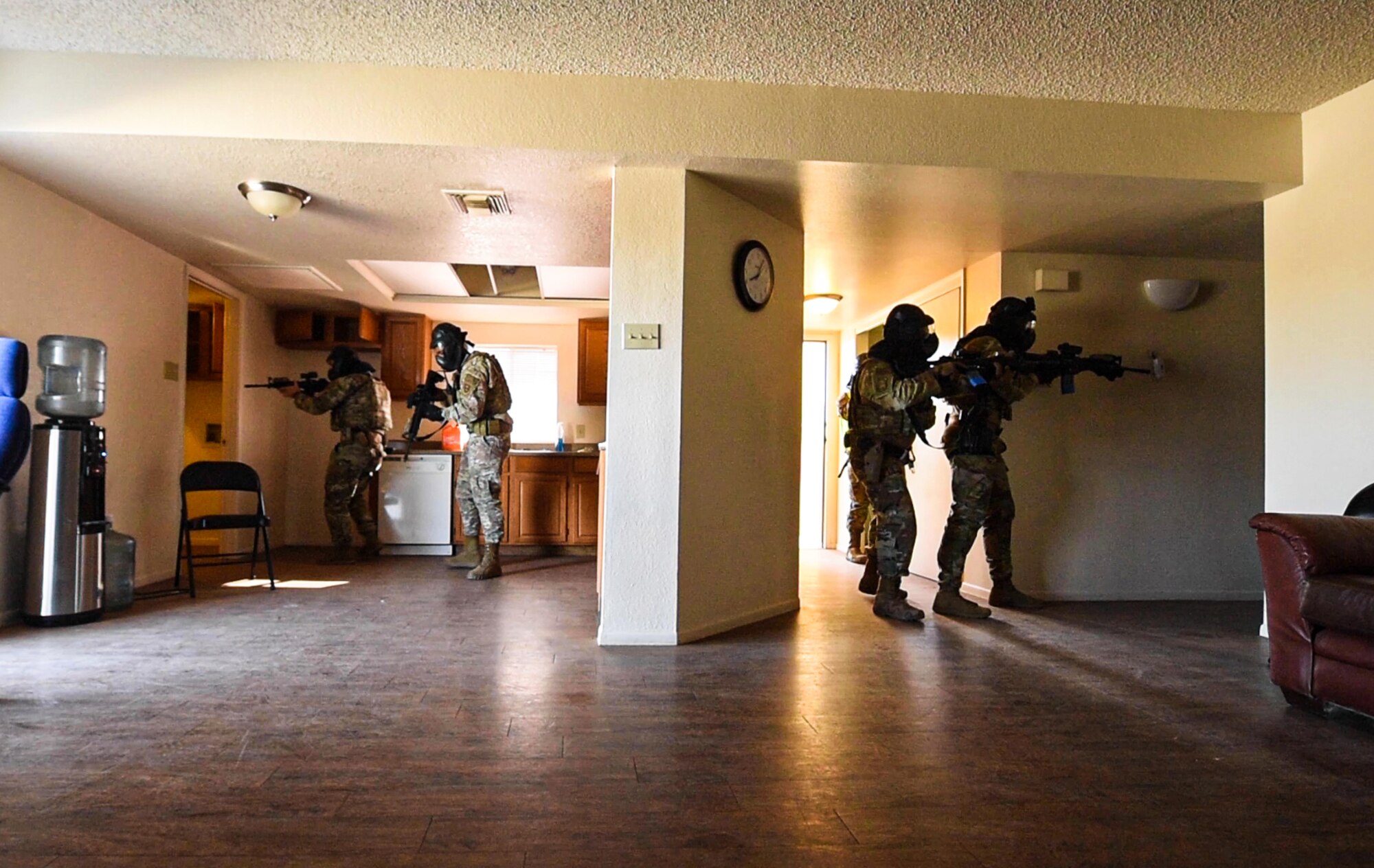 Airmen from the 56th Security Forces Squadron clear a house during a barricaded suspect demo, May 14, 2021, at Luke Air Force Base, Arizona.