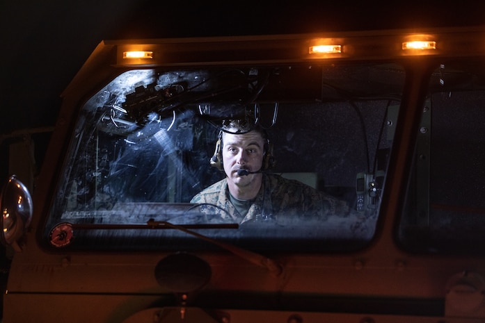 U.S. Marine Corps Cpl. Joseph Pursley, a motor vehicle operator, conducts a radio check from inside a logistics vehicle system replacement on Kirkland Air Force Base, New Mexico, May 13, 2021. Marines with 2nd Transportation Battalion, Combat Logistics Regiment 2, 2nd Marine Logistics Group conducted a convoy across the United States starting in Camp Lejeune, North Carolina and arriving at Marine Corps Air Ground Combat Center Twentynine Palms, California, in one of the longest convoys in recent Marine Corps history. (U.S. Marine Corps photo by Lance Cpl. Scott Jenkins)