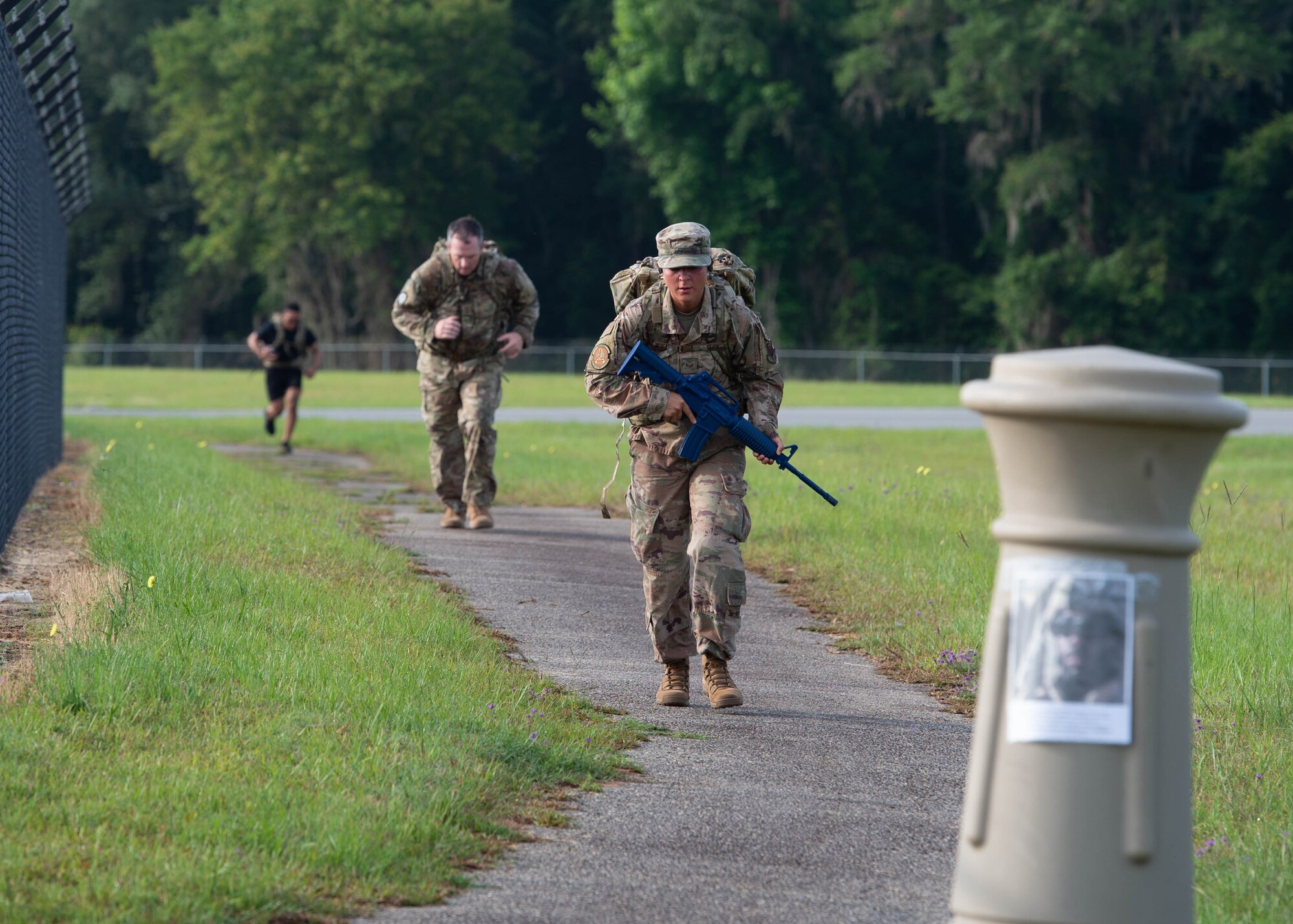 Airmen rucks by flight line.