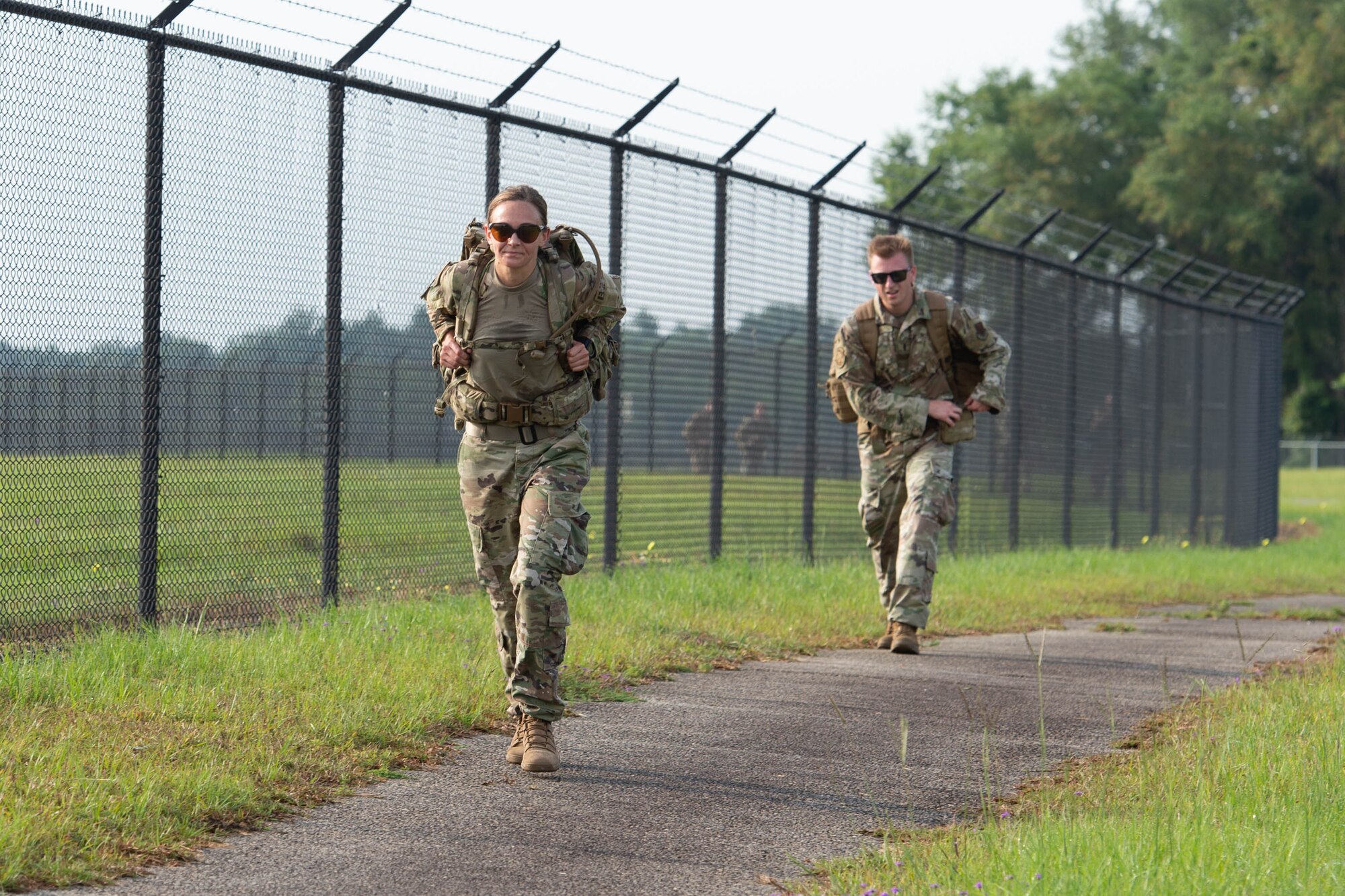 Airmen ruck by flight line.