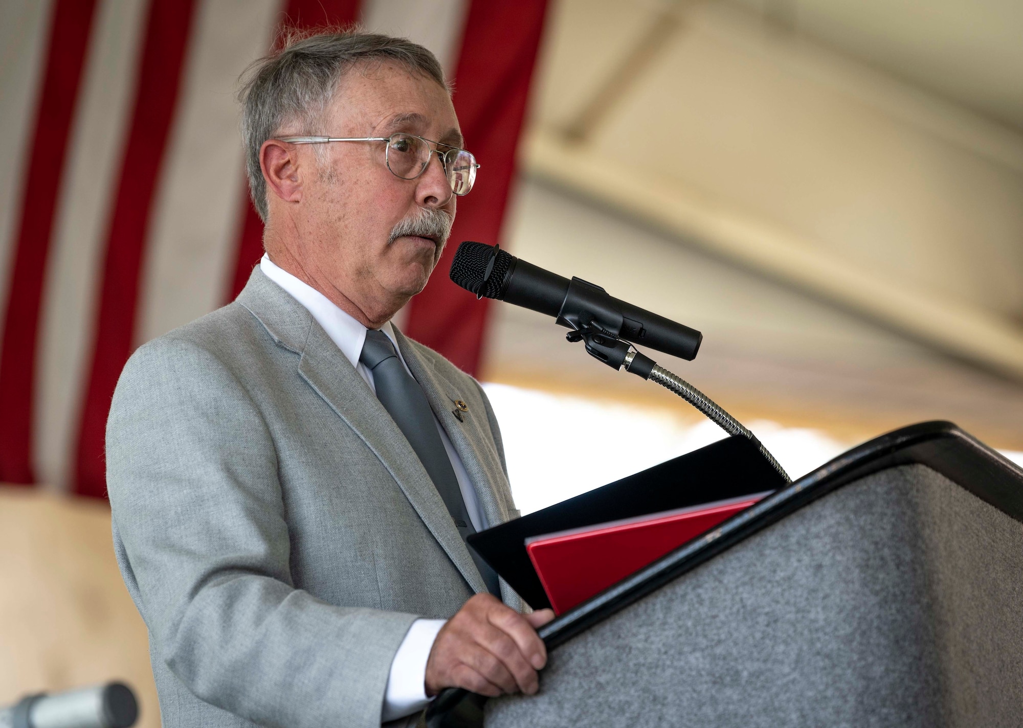 U.S. Air Force, retired, Col. Mark Roland, father of U.S. Air Force Capt. Matthew Roland, delivers a speech during a dedication ceremony.