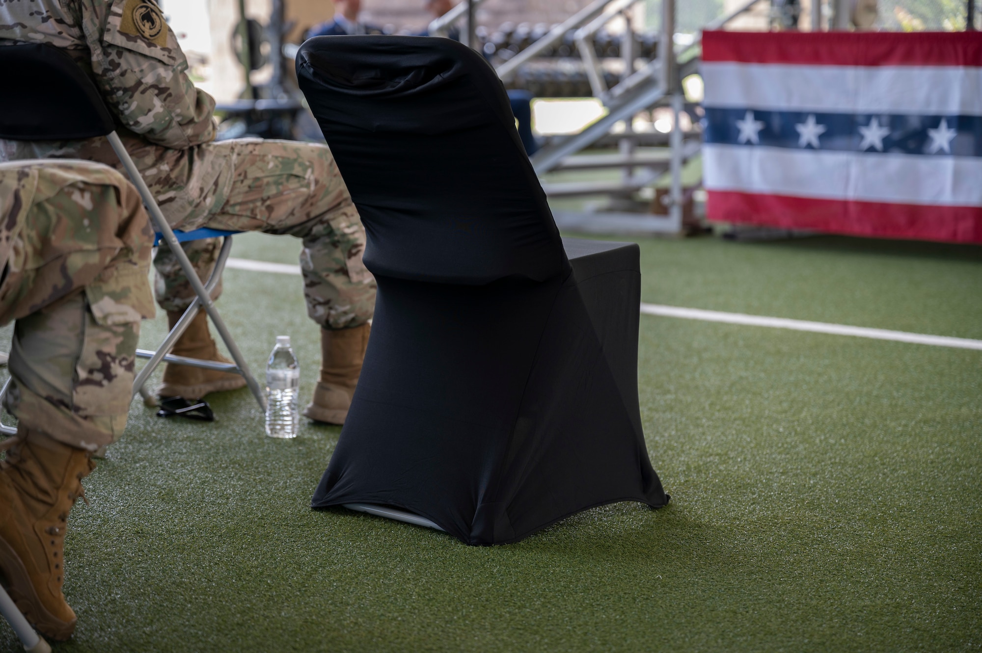 An empty chair represents fallen soldiers during a building dedication ceremony for U.S. Air Force Capt. Matthew Roland.