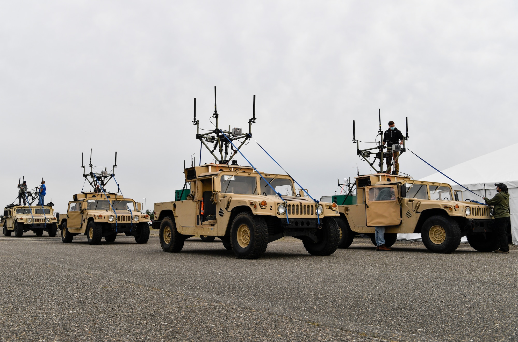 Humvee's sit on an airfield in preparation for a GBR5 radio test, May 3, 2021 on Joint Base McGuire-Dix-Lakehurst, N.J. The GBR5 radio is a candidate to be a part of the U.S. Army man to man teaming program, which allows for robotic combat vehicles. (U.S. Air Force photo by Staff Sgt. Jake Carter)