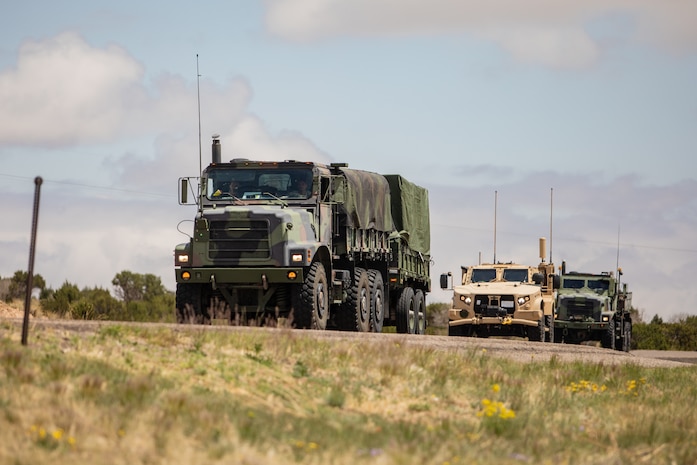 U.S. Marines drive tactical vehicles onto the highway near Albuquerque, New Mexico , May 11, 2021. Marines with 2nd Transportation Battalion, Combat Logistics Regiment 2, 2nd Marine Logistics Group conducted a convoy across the United States starting in Camp Lejeune, North Carolina and arriving at Marine Corps Air Ground Combat Center Twentynine Palms, California, in one of the longest convoys in recent Marine Corps history. (U.S. Marine Corps photo by Lance Cpl. Scott Jenkins)