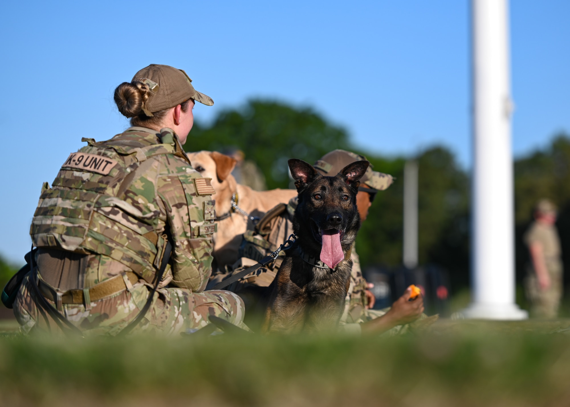 U.S. Air Force Staff Sergeant Dylan Boone, Stands beside the fallen member he carried throughout an early morning ruck march during National Police Week at Joint Base Langley-Eustis, Virginia, May 13, 2021. National Police Week is held to recognize the contributions and dedication of law enforcement and honor officers who have made the ultimate sacrifice in the line of duty.