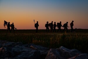 U.S. Air Force Staff Sergeant Dylan Boone, Stands beside the fallen member he carried throughout an early morning ruck march during National Police Week at Joint Base Langley-Eustis, Virginia, May 13, 2021. National Police Week is held to recognize the contributions and dedication of law enforcement and honor officers who have made the ultimate sacrifice in the line of duty.