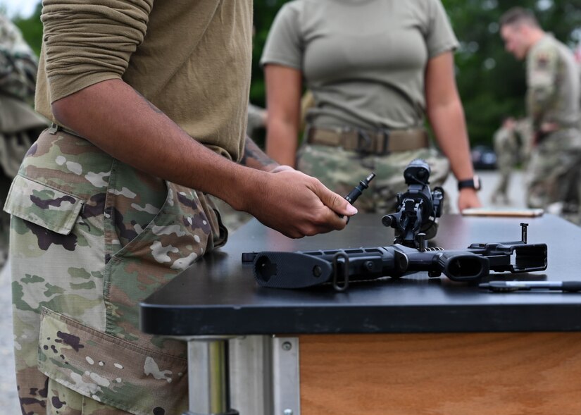 Members of the 633rd Security Forces Squadron competed in the Defender’s Challenge as part of National Police Week at Joint Base Langley-Eustis, Virginia, May 13, 2021. Teams of four competed in five timed stations such as weapon assembly and disassembly and a litter-carry, to see which team could complete the event in the least amount of time.